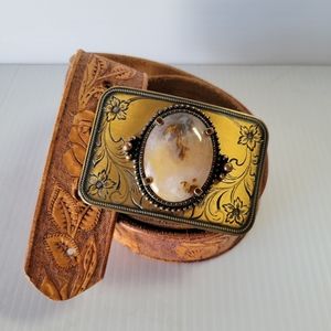 Tooled leather belt with stone buckle.